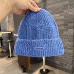 Blue ribbed knit beanie with wide cuff and woven "pipiswoot" label