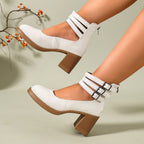 White croc-embossed platform ankle strap pumps with block heels and triple buckle cuff