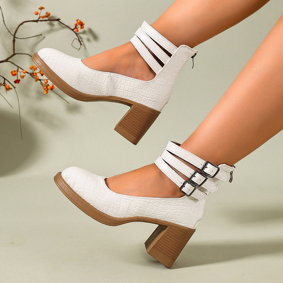 White croc-embossed platform ankle strap pumps with block heels and triple buckle cuff