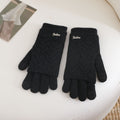 Women’s black fingerless knit gloves with ribbed cuffs and textured wave pattern