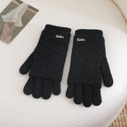 Women’s black fingerless knit gloves with ribbed cuffs and textured wave pattern
