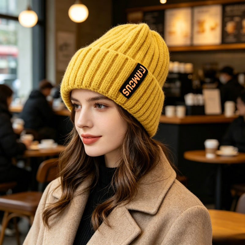 Chunky ribbed beanie in mustard yellow with folded cuff and letter patch