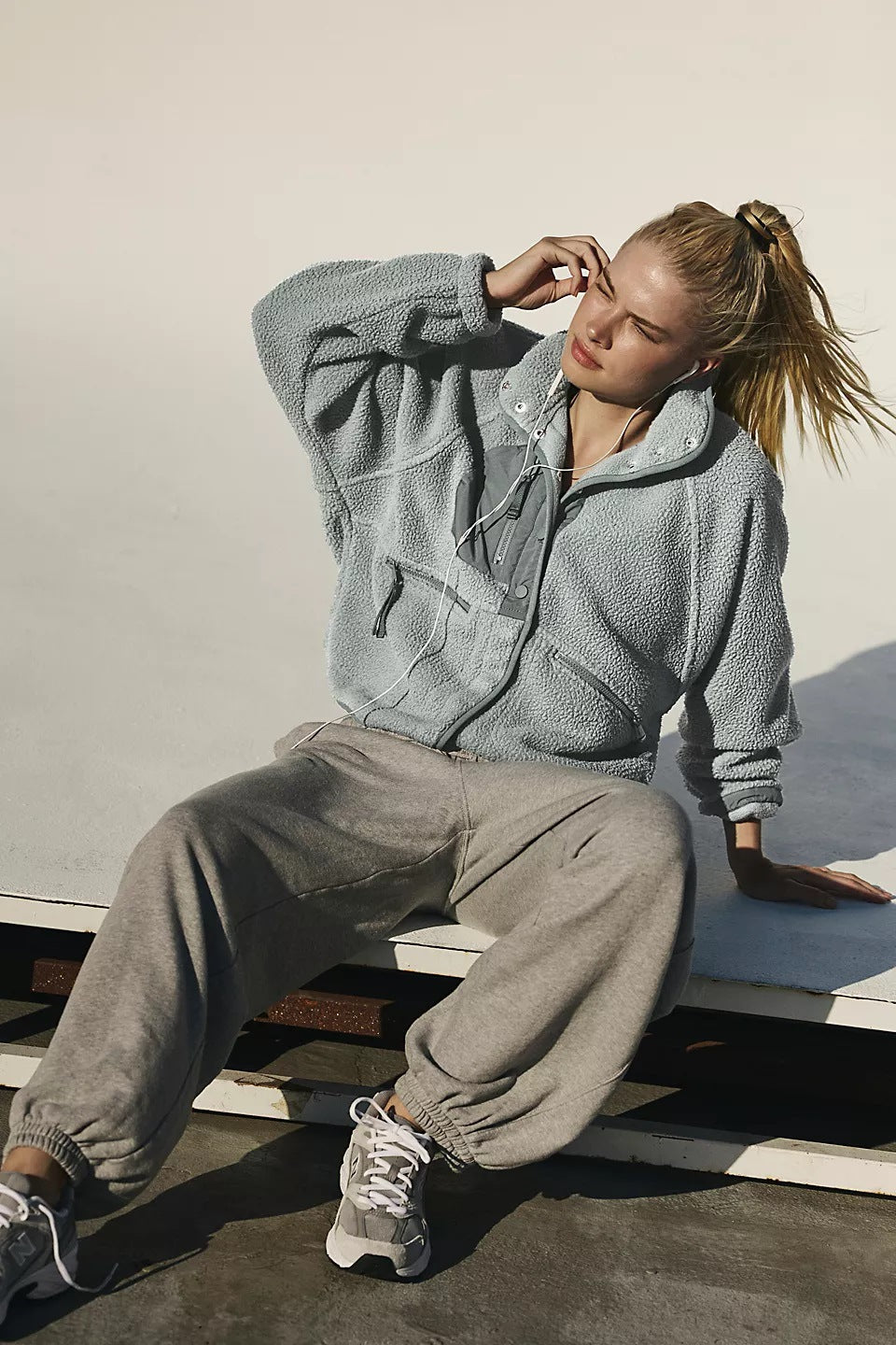 Women’s sherpa jacket in gray with snap front and stand collar; zip pockets