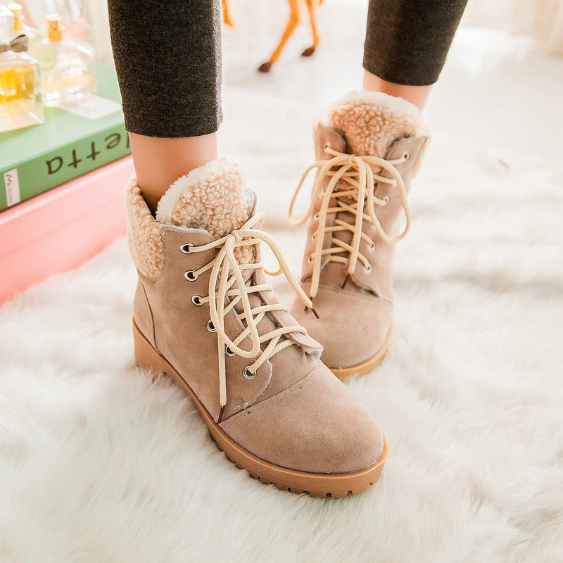 Beige lace-up ankle boots with sherpa cuffs and lug soles