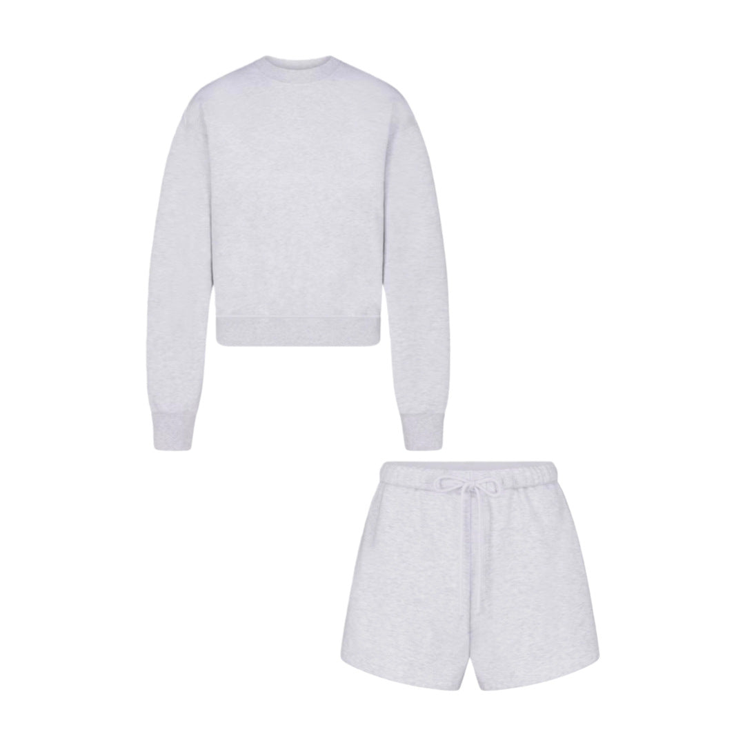 Light gray crew neck sweatshirt and matching drawstring shorts, two-piece lounge set.