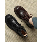 Pair of women’s lace-up ankle boots: black and dark brown, round toe, chunky lug sole