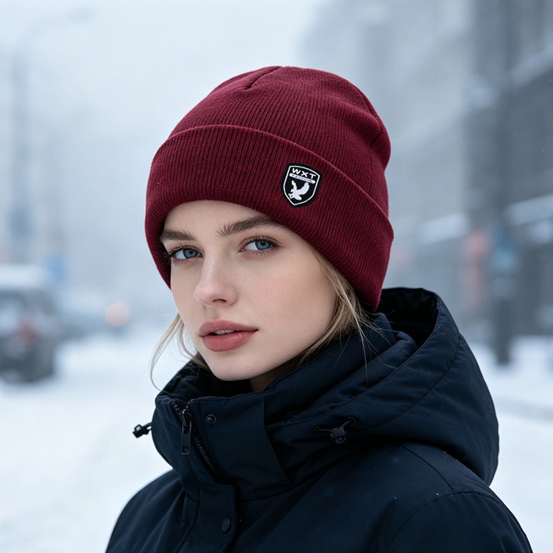 Wine red ribbed knit beanie with fleece lining and logo patch