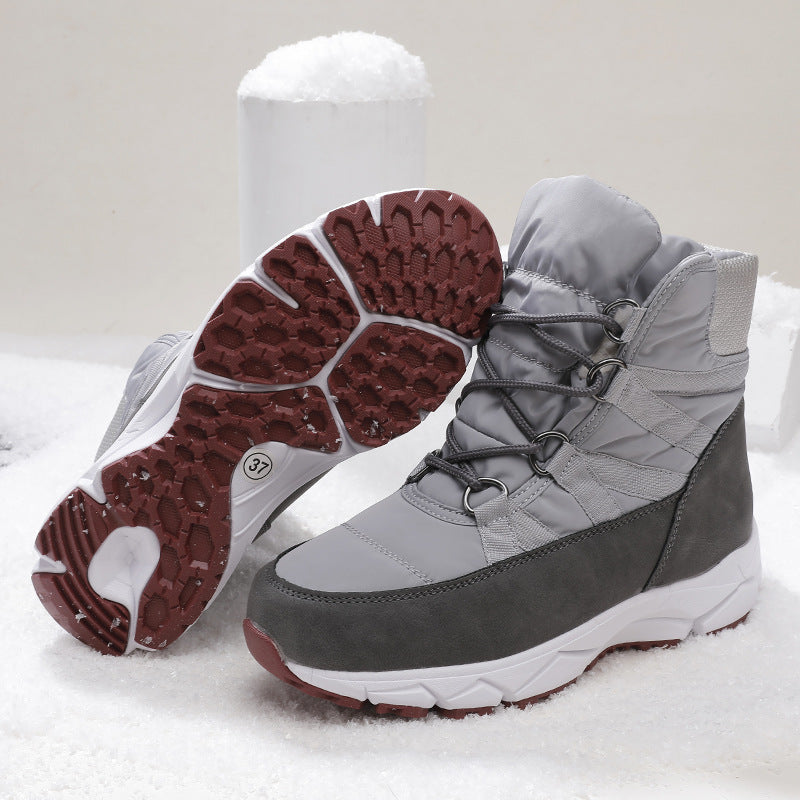 Women's light gray lace-up snow boots with textured rubber outsole and dark side trim