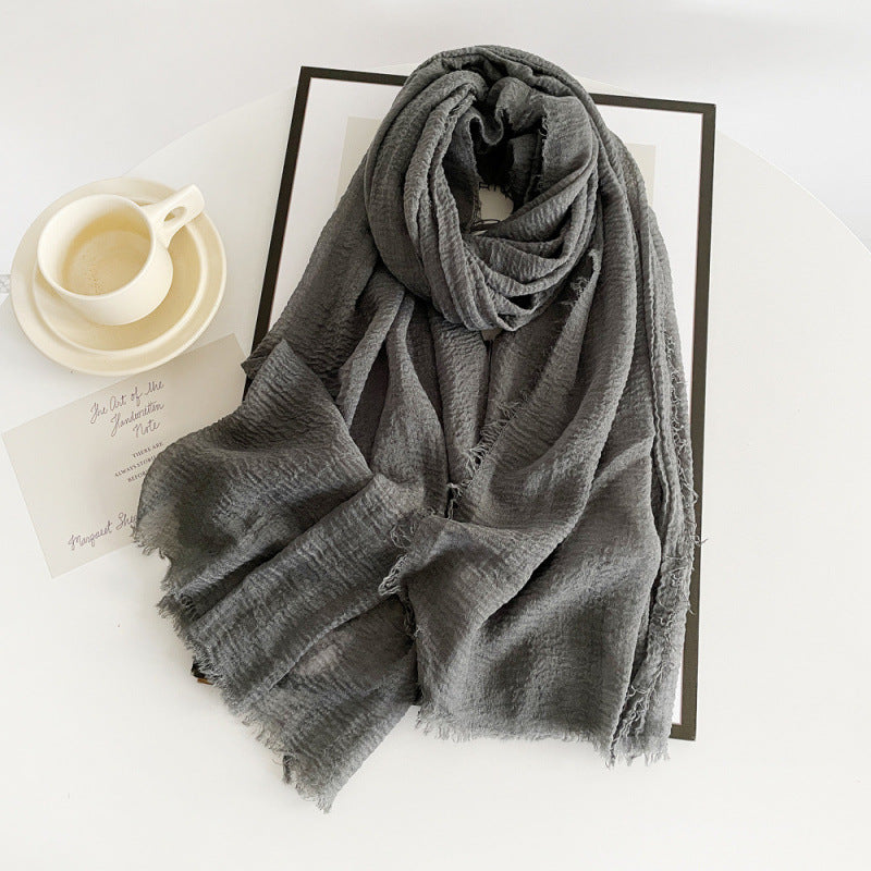 Gray cotton gauze scarf with crinkle texture and frayed fringe ends, long wrap