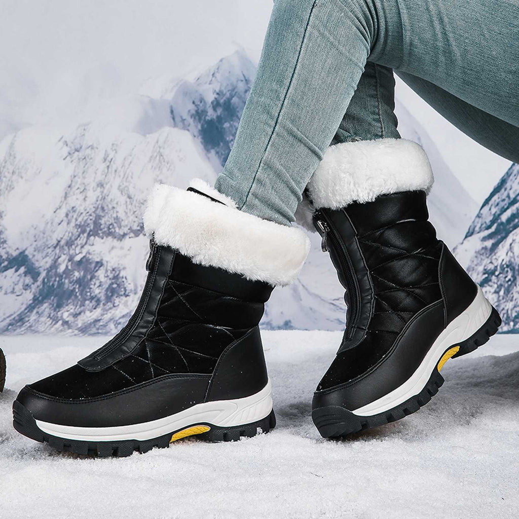 Black mid-calf zip-up snow boots with faux fur cuffs and lug sole.