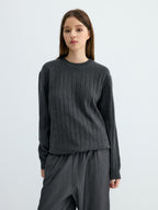 Dark gray ribbed crew neck sweater with wide knit ribs and banded cuffs