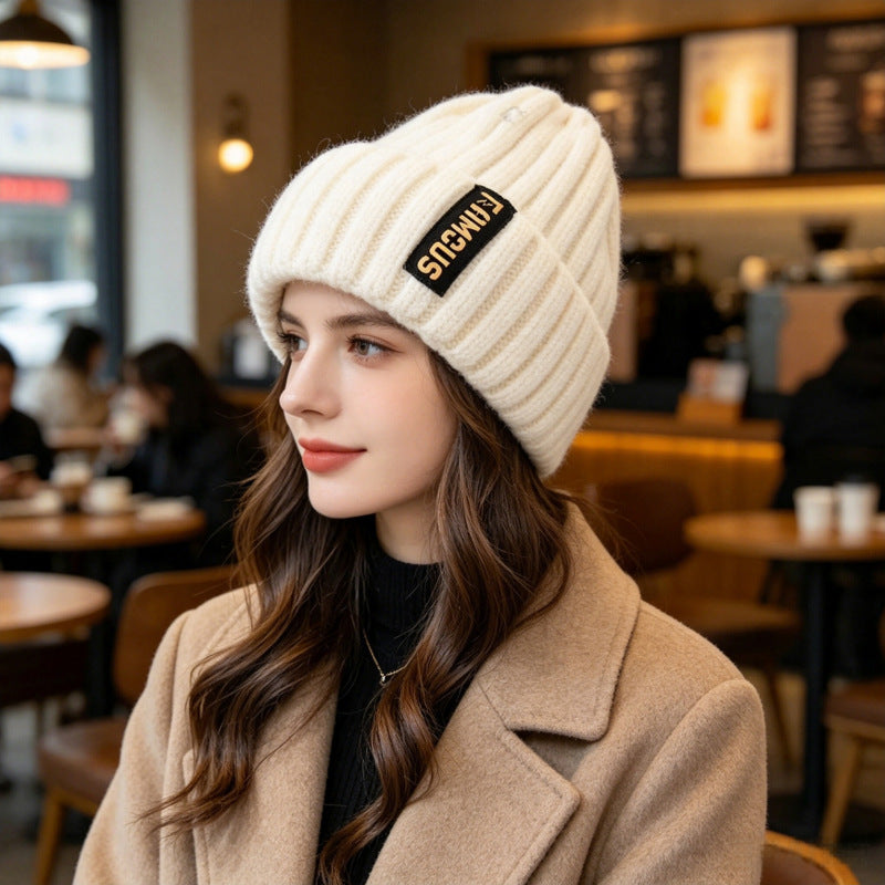 Chunky ribbed beanie in off-white with folded cuff and letter patch