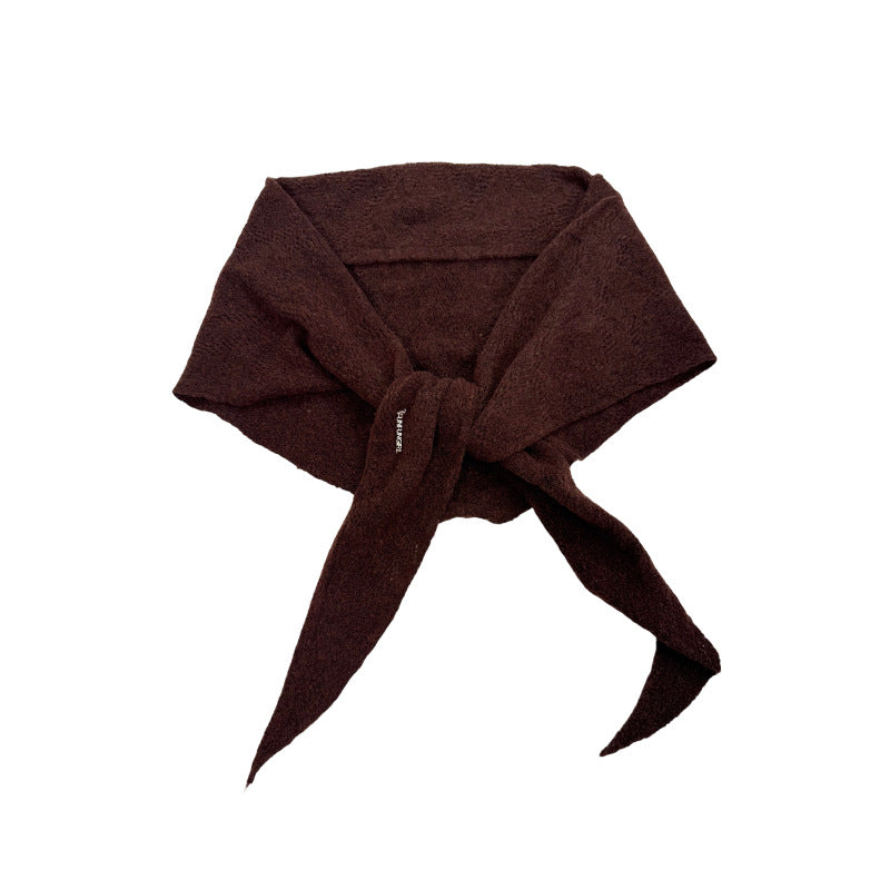 Dark brown knit triangle scarf tied at the center, with two pointed ends.