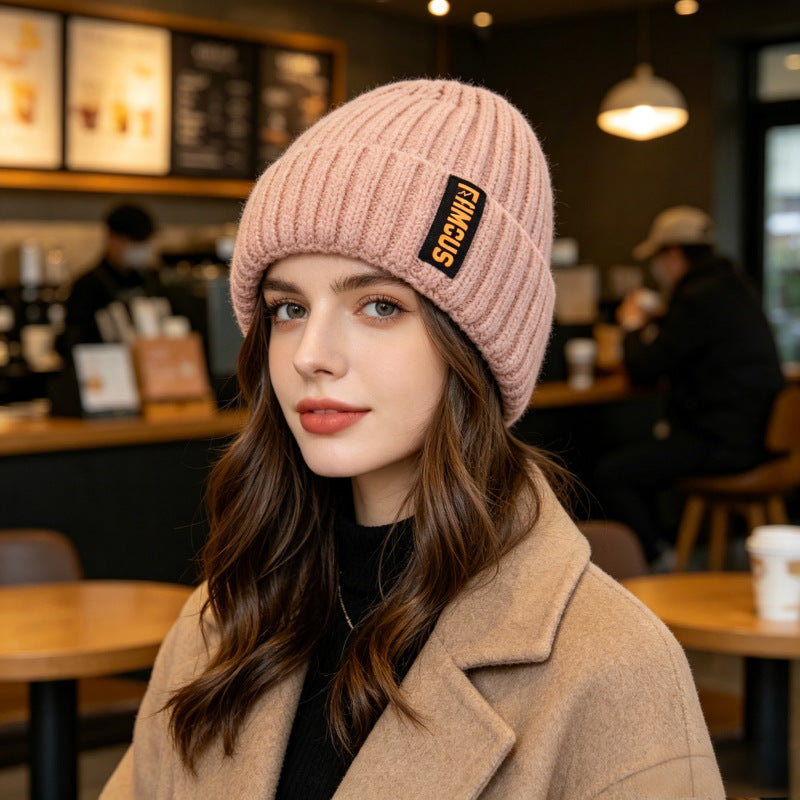 Chunky ribbed beanie in dusty pink with folded cuff and letter patch