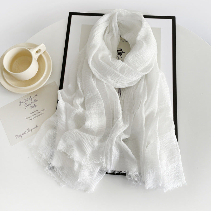 White cotton gauze scarf with crinkle texture and frayed fringe ends, long wrap