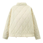 Off-white quilted back view stand-collar zip-up jacket with elastic hem and long sleeves.