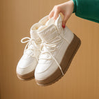 Fleece-lined lace-up snow boots in white with padded ankle collar and platform sole