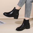 Black chelsea ankle boots with chunky block heel and round toe, pull-on style