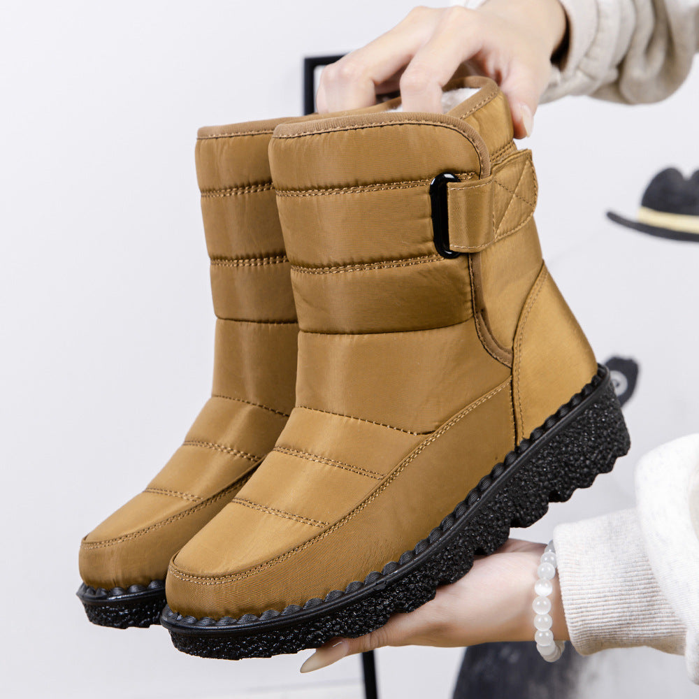 Mustard quilted platform snow boots with padded collar, drawstring toggle, and side strap.