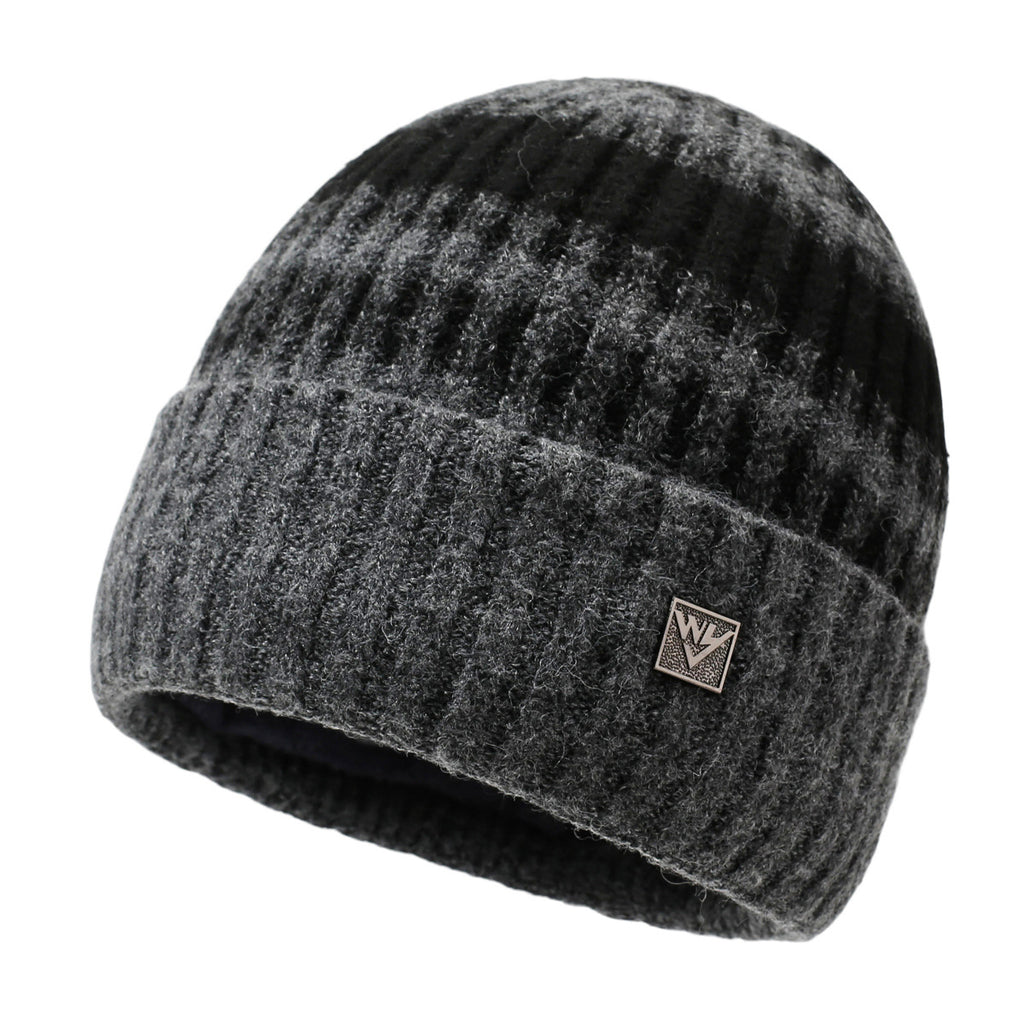 Striped knit beanie in dark charcoal gray with light pattern and metal badge