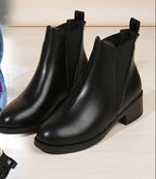 Black chelsea ankle boots with chunky block heel, round toe, pull-on style