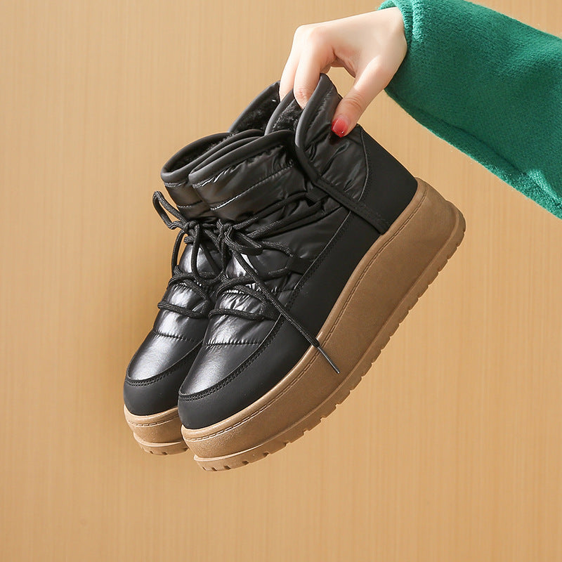 Fleece-lined lace-up snow boots in black with quilted nylon panels and tan platform sole