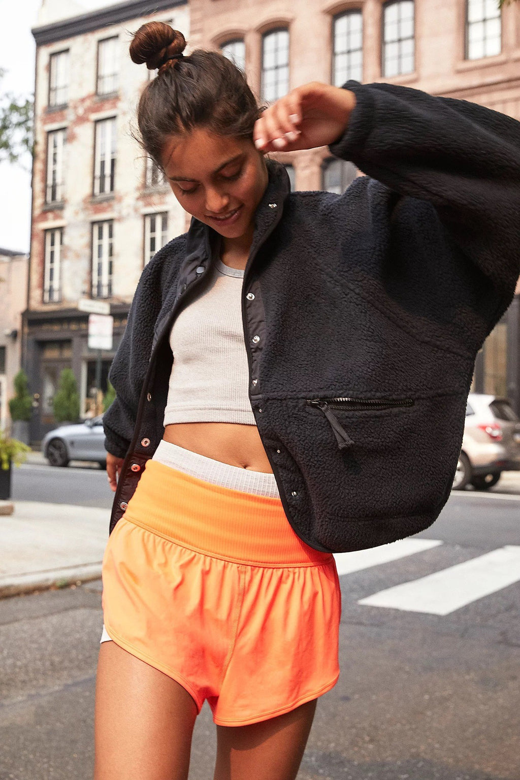 Women’s sherpa jacket in charcoal/black with snap front, stand collar, and zip pockets