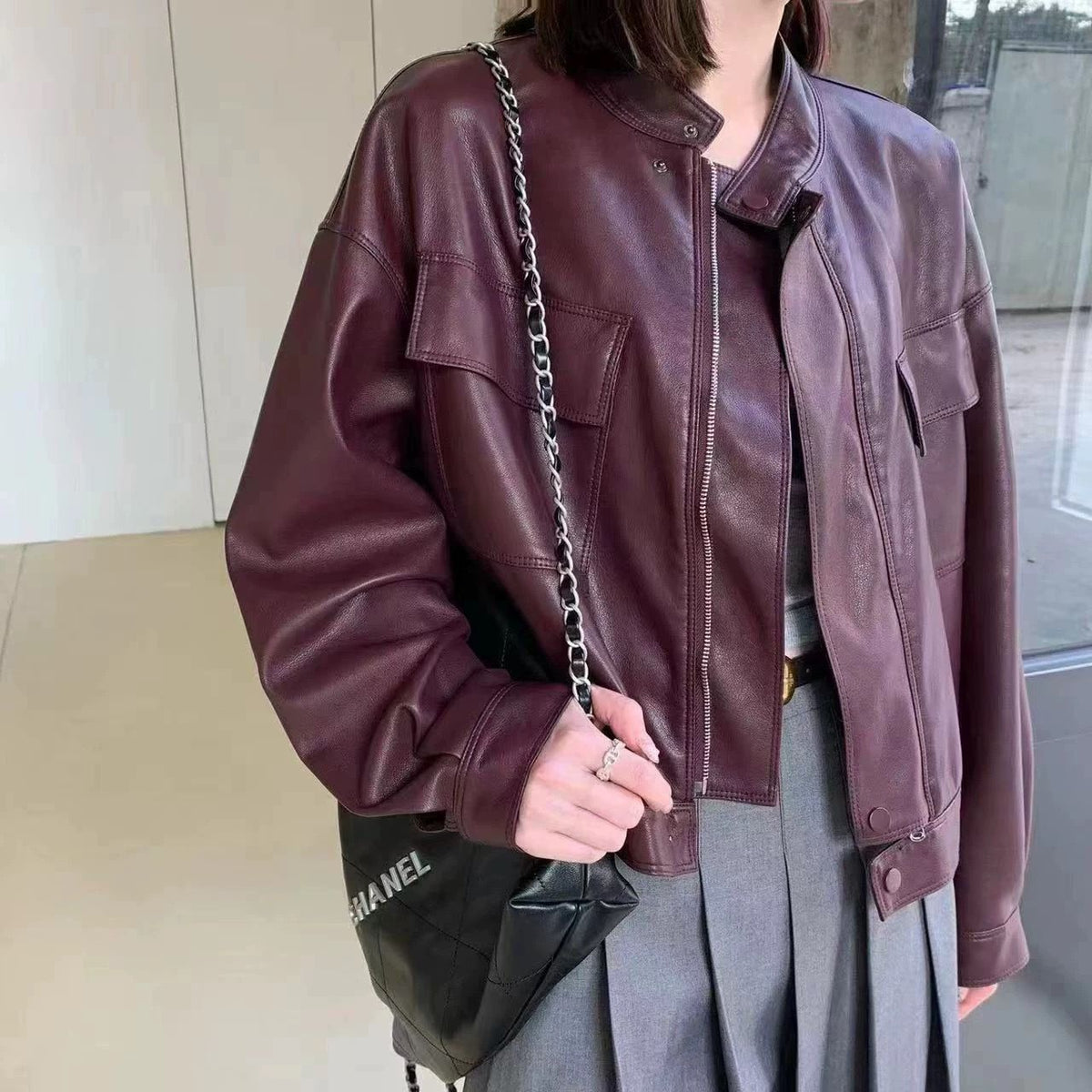 Cropped burgundy faux leather jacket with stand collar, zip front, flap pockets