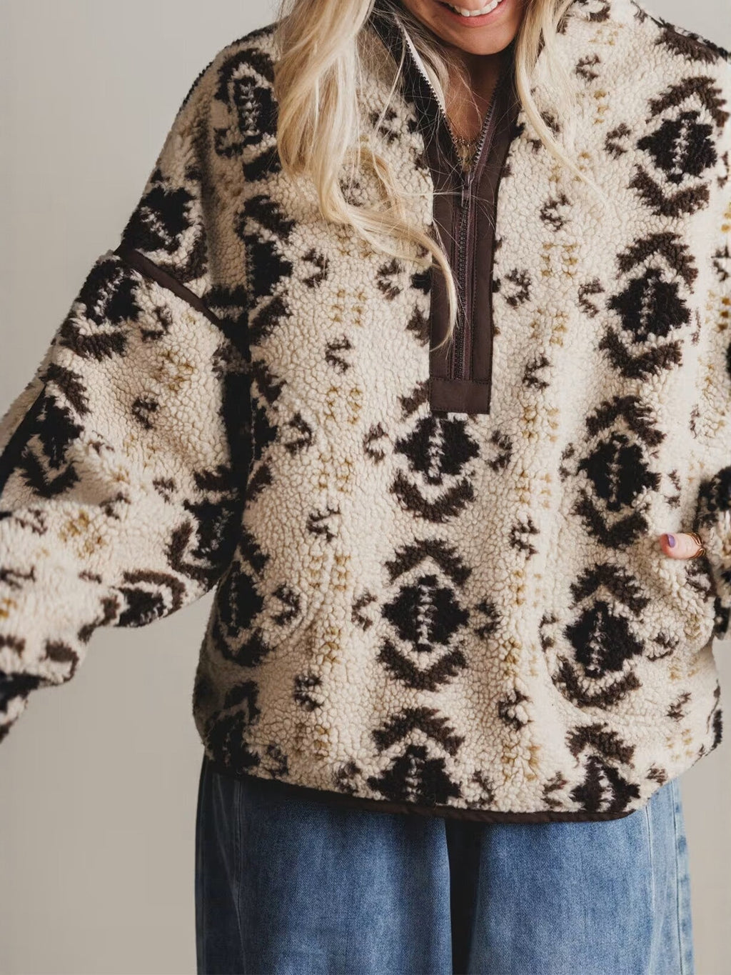 Women's cream sherpa quarter-zip pullover with dark aztec pattern, long sleeves
