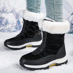 Black mid-calf zip-up snow boots with faux fur cuffs and traction lug sole.