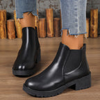 Women’s chunky Chelsea boots in black with elastic side panels and lug sole, block heel.