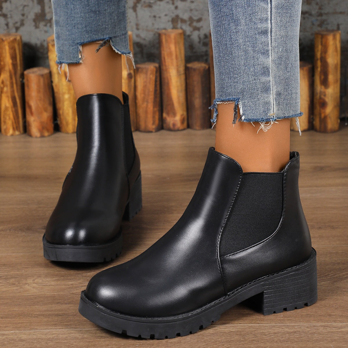 Women’s chunky Chelsea boots in black with elastic side panels and lug sole, block heel.