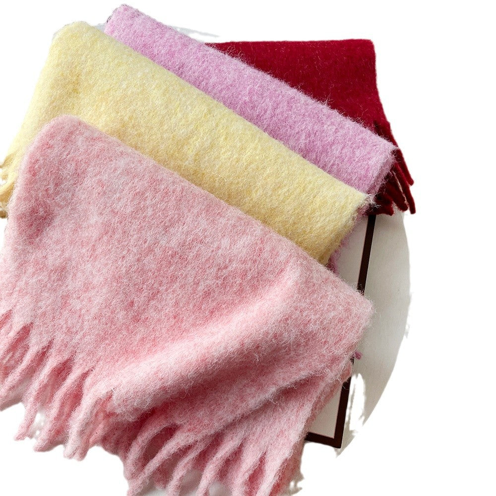 Oversized fuzzy scarf with fringe ends, folded; pink, yellow, and lavender sections visible
