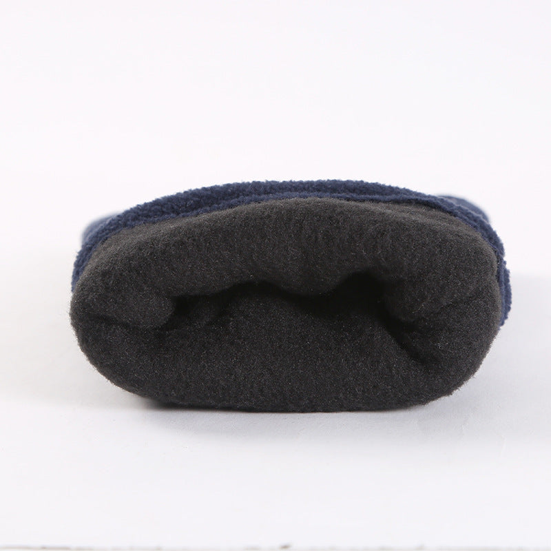 Folded dark fleece winter glove, showing soft polar fleece texture and seam