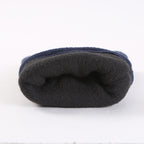 Folded dark fleece winter glove, showing soft polar fleece texture and seam