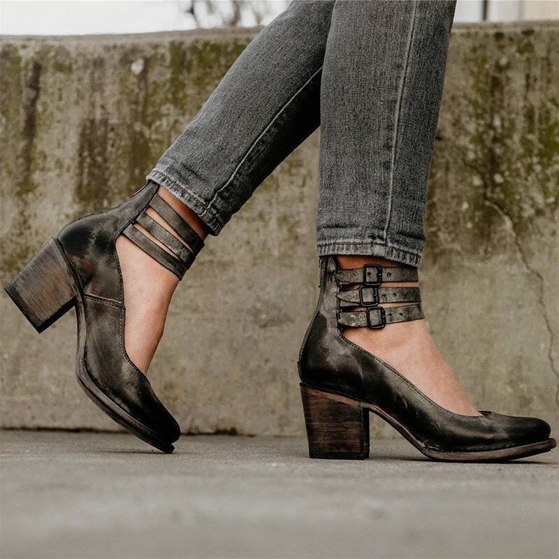 Black closed-toe block heel pumps with ankle strap and double buckle