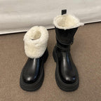 Pair of black faux leather winter boots with folded faux-fur cuffs and platform soles