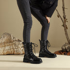 Black lace-up combat snow boots with glossy upper and chunky lug sole