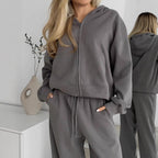 Women’s gray zip-up hoodie with drawstring waist sweatpants set in soft fleece.