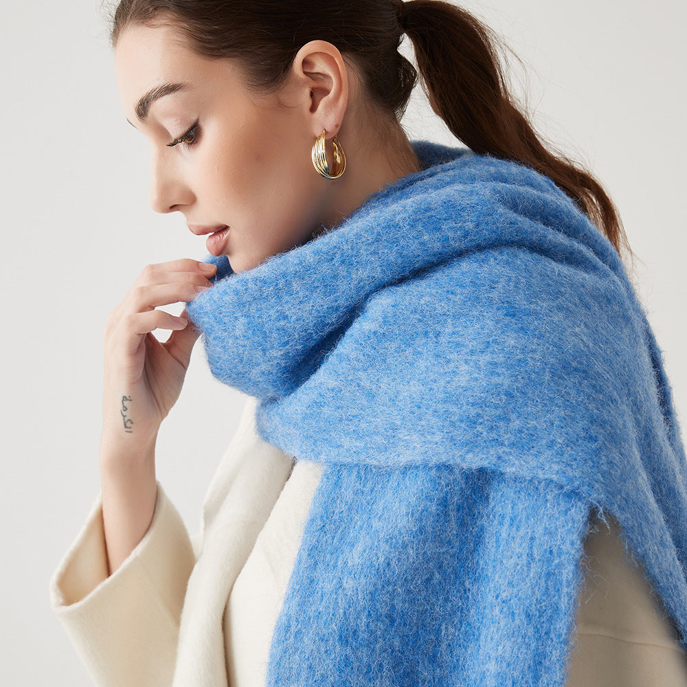 Oversized fuzzy mohair-blend scarf with fringe ends, sky blue, worn draped over shoulders