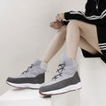Women's light gray lace-up snow boots with quilted puffer panels and sneaker sole