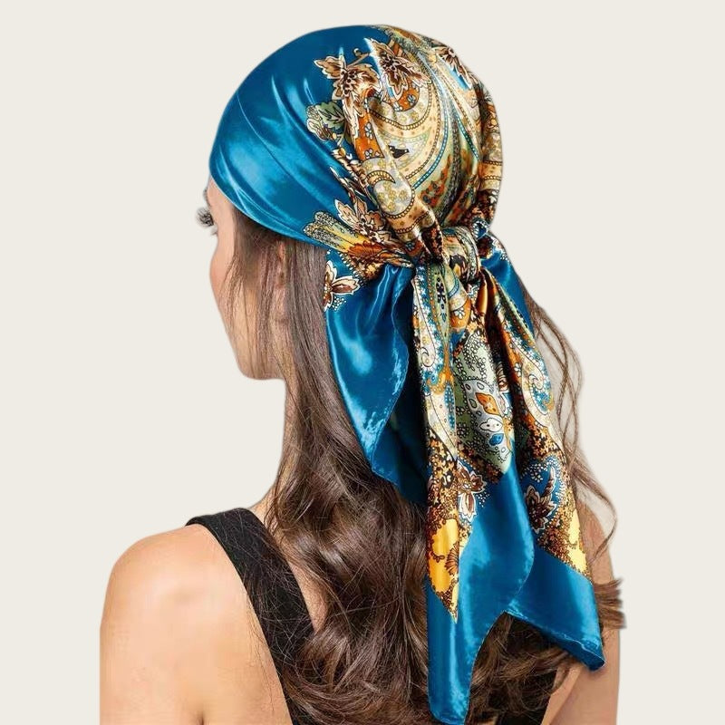 Large satin square scarf in blue with gold paisley print, tied head wrap