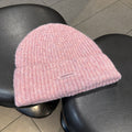 Pink ribbed knit beanie with wide cuff and woven "pipiswoot" label