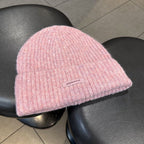 Pink ribbed knit beanie with wide cuff and woven "pipiswoot" label
