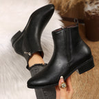 Black pointed-toe ankle booties with side zip, low block heel, and smooth finish