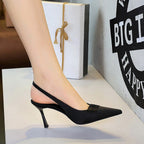 Black satin slingback heels with pointed toe, stiletto heel, and slingback strap.