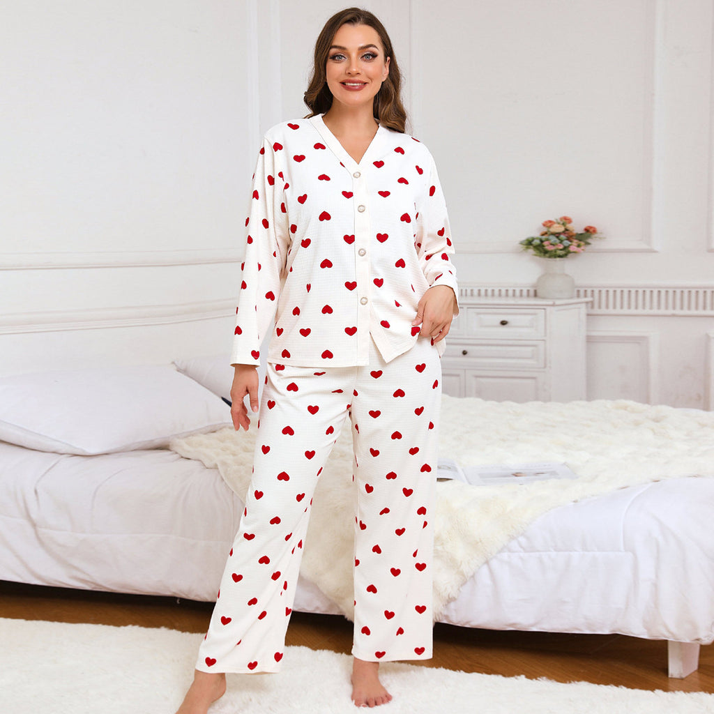 Women’s heart-print pajama set, front view with red hearts on white long-sleeve top and pants