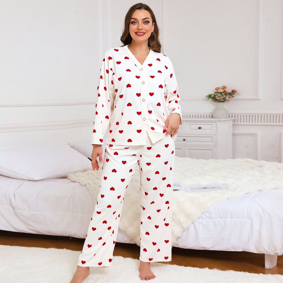 Women’s heart-print pajama set, front view with red hearts on white long-sleeve top and pants