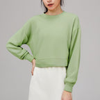 Green cropped crewneck sweatshirt with drop-shoulder long sleeves and ribbed hem