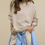 Oversized crewneck sweatshirt in light beige with exposed seams and slouchy fit